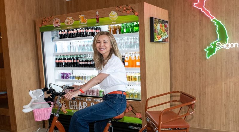 lynn lee smiling in front of beverages section of store